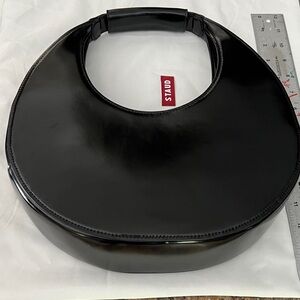 STAUD Glossy Black Crescent Bag 1 of  Rebecca’s bags from Ted Lasso TV Show